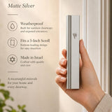Person naturally holding the aluminum matte silver mezuzah, showcasing its true size and details for online store presentation.