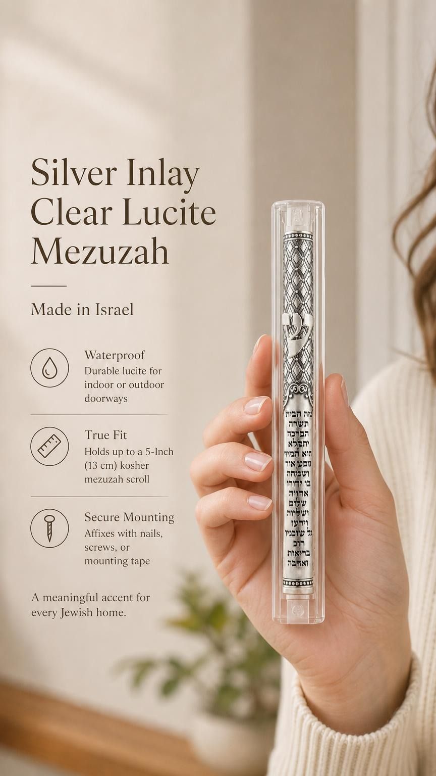 A person holding a clear lucite mezuzah with a floating silver inlay in a premium editorial style.