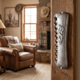Artisan handcrafted pewter mezuzah with leather lacing and Hebrew Shin, Dalet, Yud motif, mounted on a doorway for Jewish home.