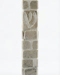 Gray Jerusalem stone mezuzah, handcrafted in Israel, with engraved Hebrew letters and decorative motifs, 5-inch size.