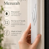 Large white acrylic mezuzah cover mounted vertically on a front doorpost, showing its slim seven-inch profile and sculpted silver Shin