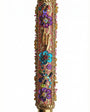 Intricate handmade Mezuzah decorated with colorful sequins and stones, mounted on a clean white background with soft reflection.