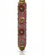 Pink handmade Mezuzah decorated with sequins and stones, crafted by Israeli artist Eva Mishaan, shown on a white studio background with soft reflection.