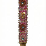 Pink handmade Mezuzah decorated with sequins and stones, crafted by Israeli artist Eva Mishaan, shown on a white studio background with soft reflection.