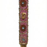 Pink handmade Mezuzah decorated with sequins and stones, crafted by Israeli artist Eva Mishaan, shown on a white studio background with soft reflection.