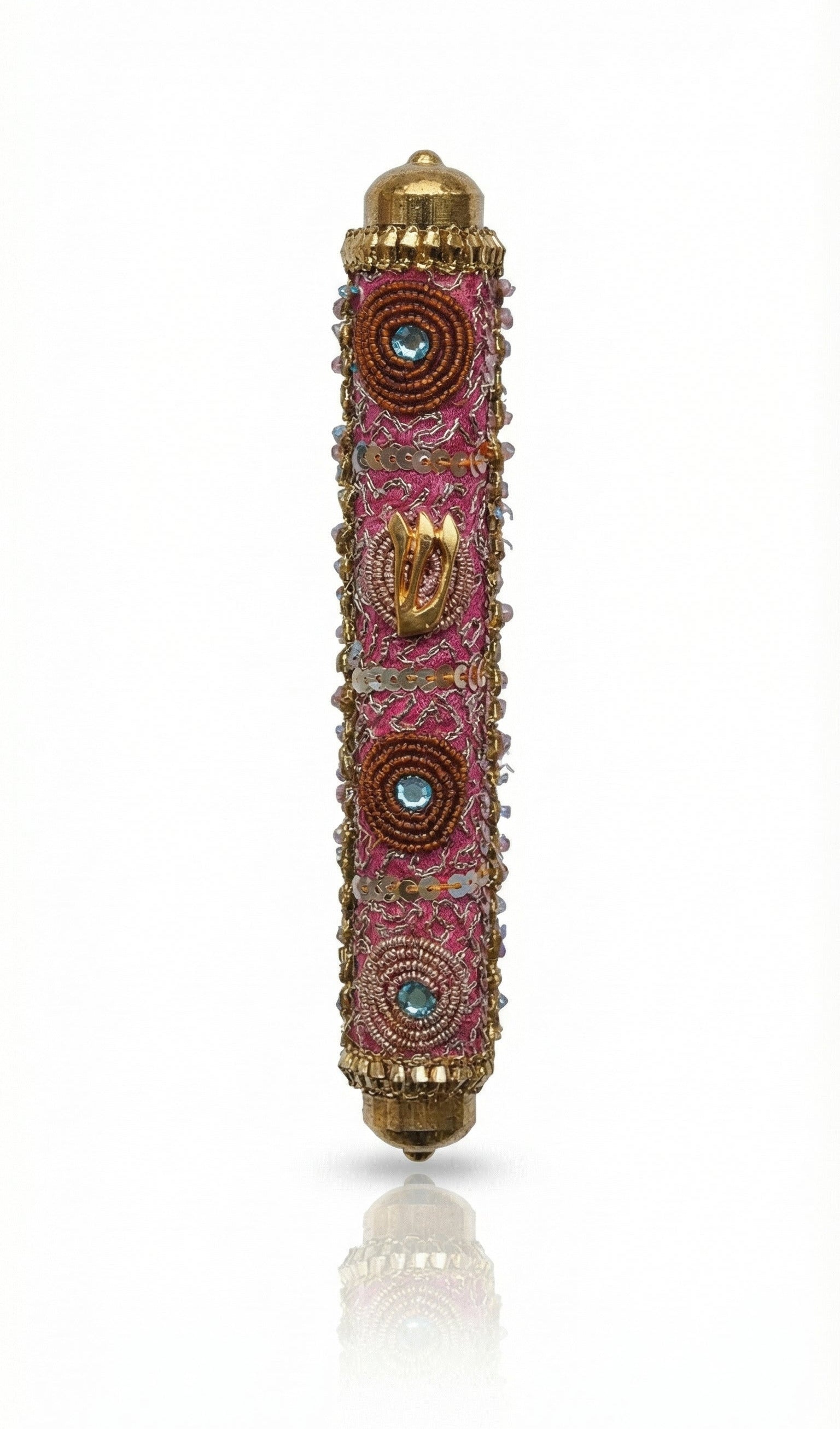 Pink handmade Mezuzah decorated with sequins and stones, crafted by Israeli artist Eva Mishaan, shown on a white studio background with soft reflection.