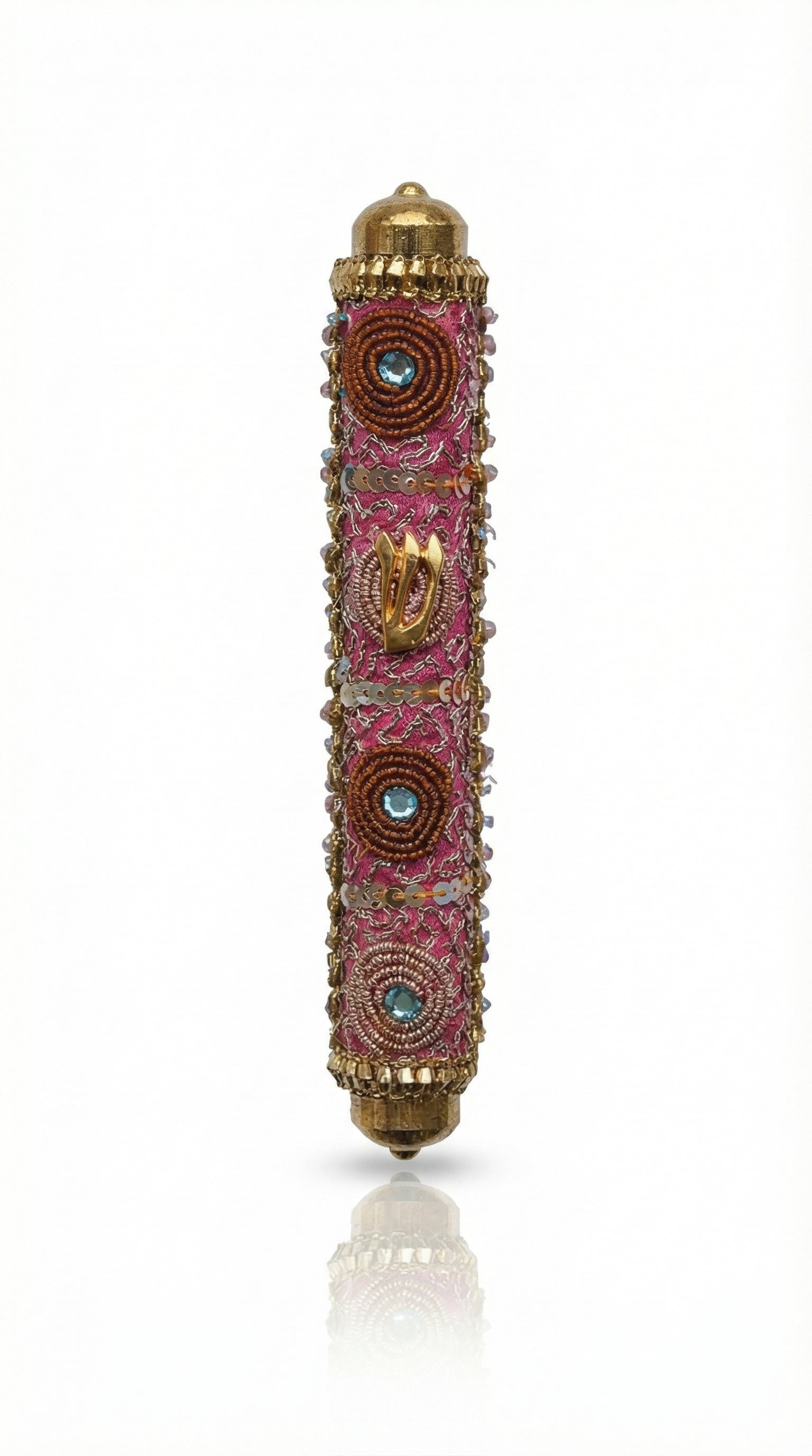 Pink handmade Mezuzah decorated with sequins and stones, crafted by Israeli artist Eva Mishaan, shown on a white studio background with soft reflection.