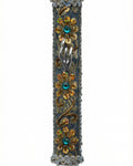 Handmade silver mezuzah decorated with colorful sequins and stones, crafted with intricate details and finished with a polished look, mounted on a white background.