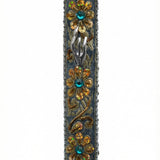 Handmade silver mezuzah decorated with colorful sequins and stones, crafted with intricate details and finished with a polished look, mounted on a white background.