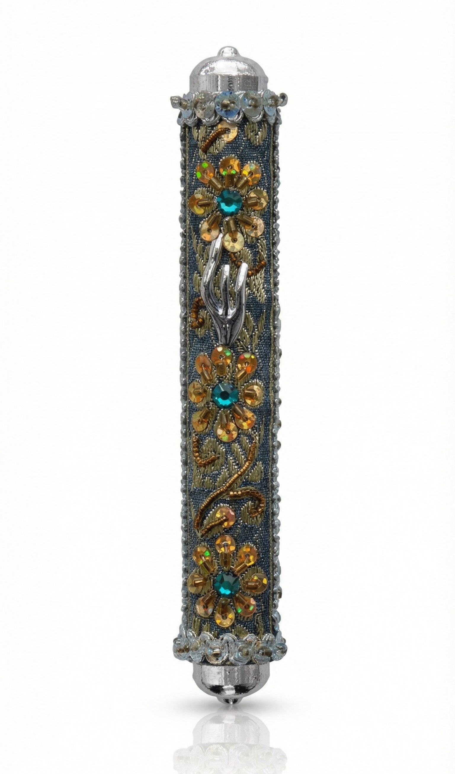 Handmade silver mezuzah decorated with colorful sequins and stones, crafted with intricate details and finished with a polished look, mounted on a white background.