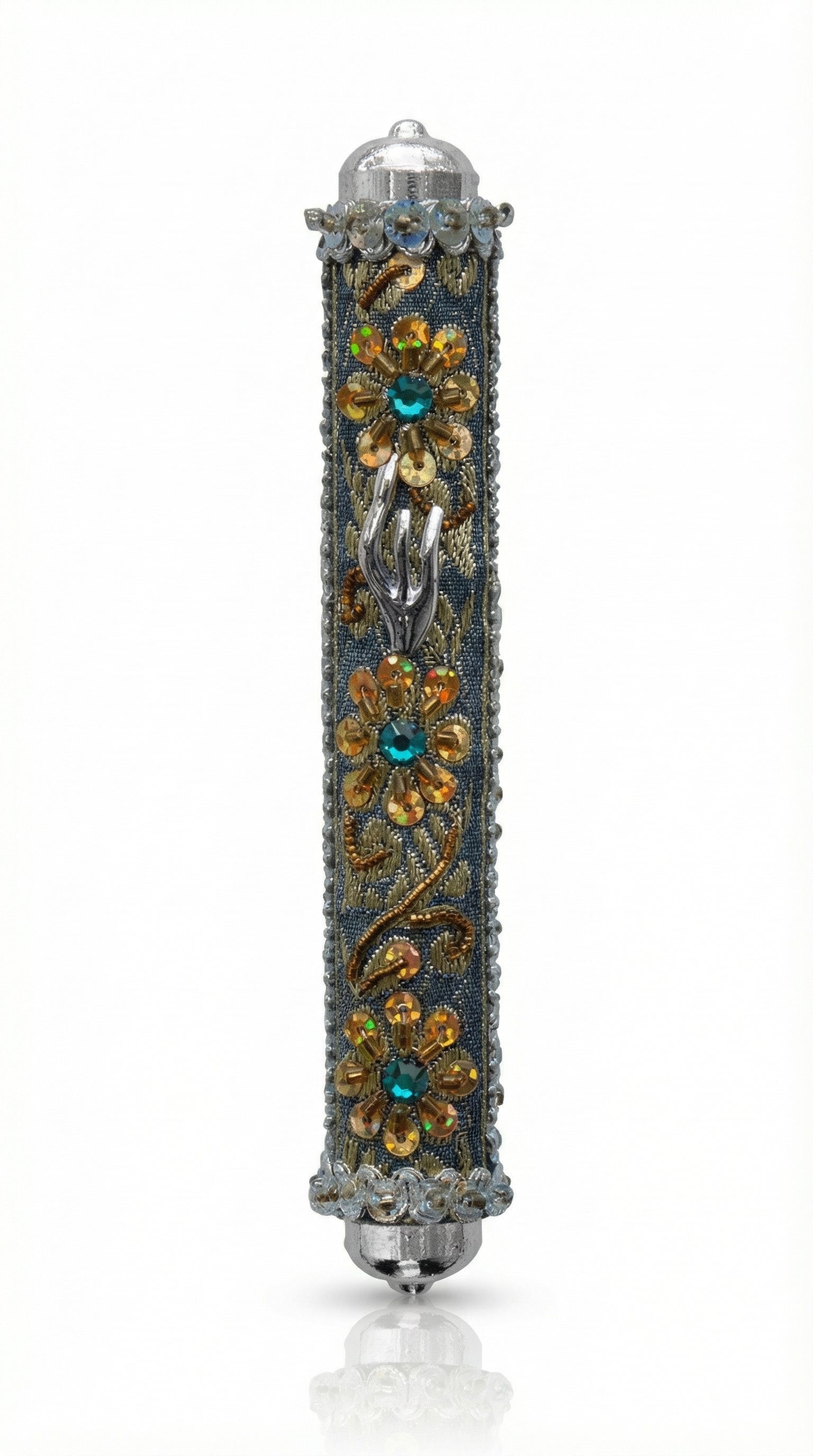 Handmade silver mezuzah decorated with colorful sequins and stones, crafted with intricate details and finished with a polished look, mounted on a white background.