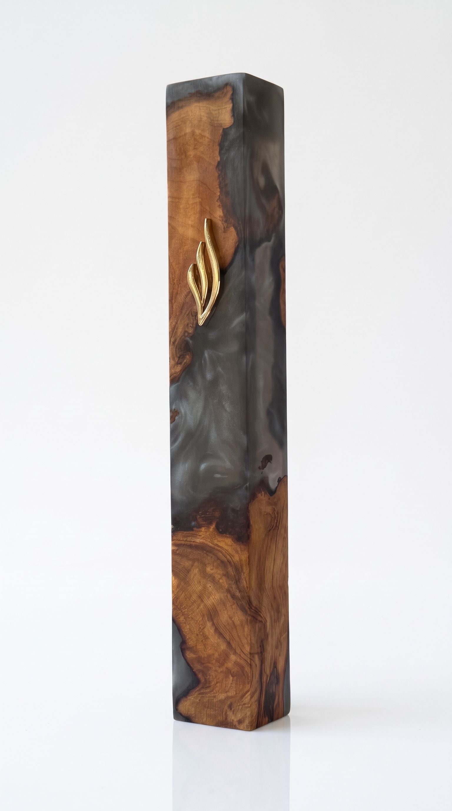 Artistic Olive Wood Charcoal Black Resin Mezuzah standing on a soft gray studio background, a handcrafted mezuzah case made in Israel where dark charcoal resin swirls through natural olive wood beneath a gold Shin, made for a 6-inch kosher scroll