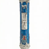 Handcrafted pewter mezuzah with blue enamel and intricate Hamsa design, featuring red hearts, Hebrew 'Chai', and 'Sha-dai' inscription.