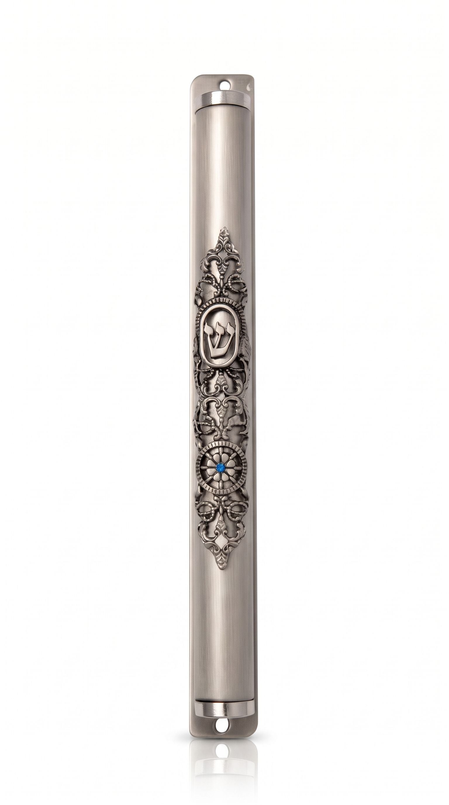 Heirloom Medallion Pewter Mezuzah shown from the front as a mezuzah cover featuring a long silver-toned pewter body, dark recessed floral scrollwork, an oval Hebrew Shin medallion and a small blue-centered decorative flower, presenting a detailed Judaica design for a Jewish home doorway