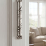 Heritage hammered pewter mezuzah on inside doorway reveal, depicting textured silver finish, Hebrew scroll accents, and rounded profile for traditional Jewish home decor.