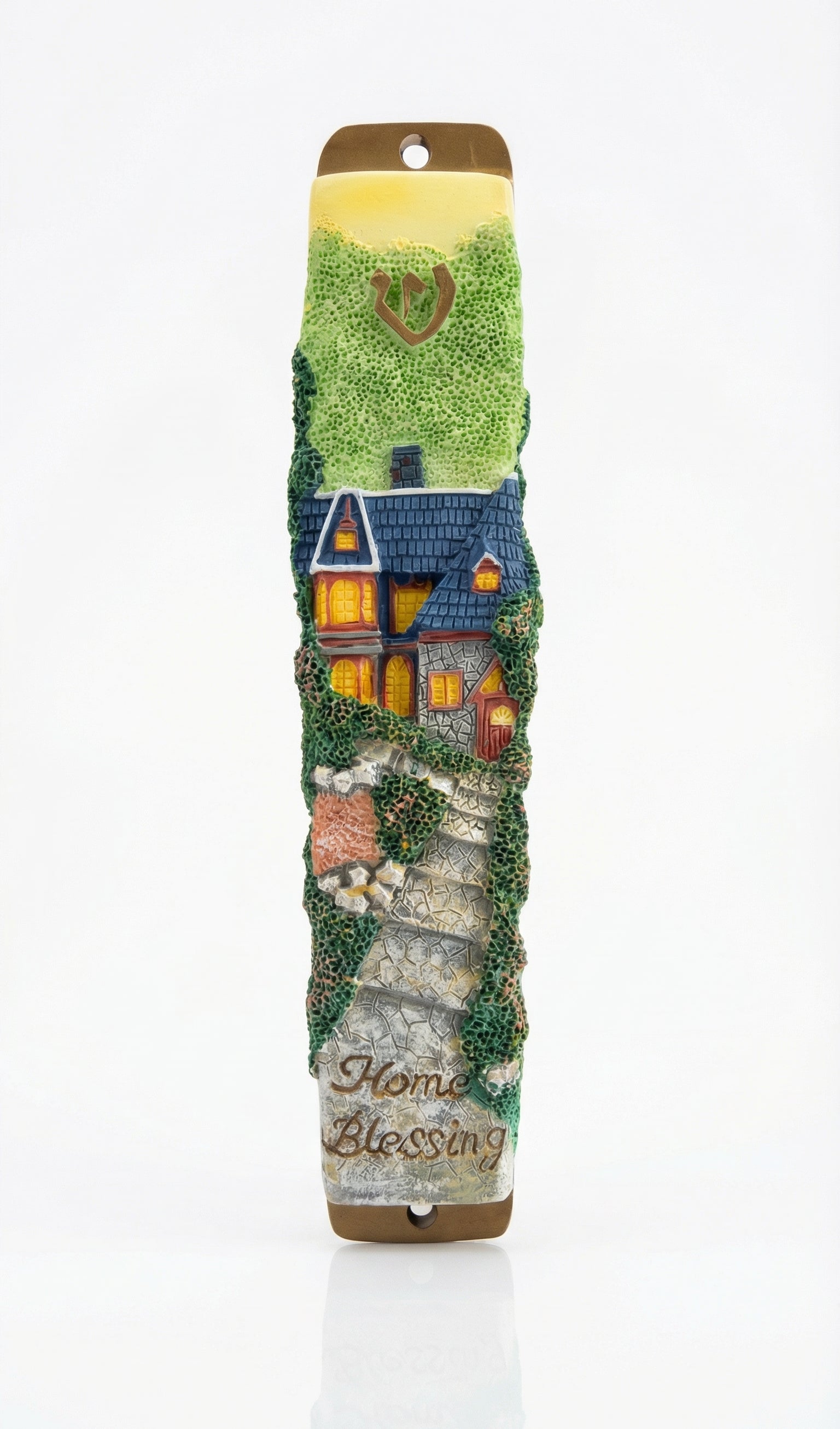 Detailed mezuzah with engraved Hebrew letters and decorative motifs on a white studio background with soft reflection.