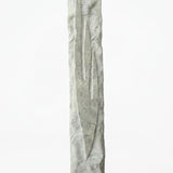 Detailed mezuzah with engraved Hebrew letters and decorative motifs on a pure white background, with a soft reflection below.