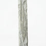 Detailed mezuzah with engraved Hebrew letters and decorative motifs on a pure white background, with a soft reflection below.