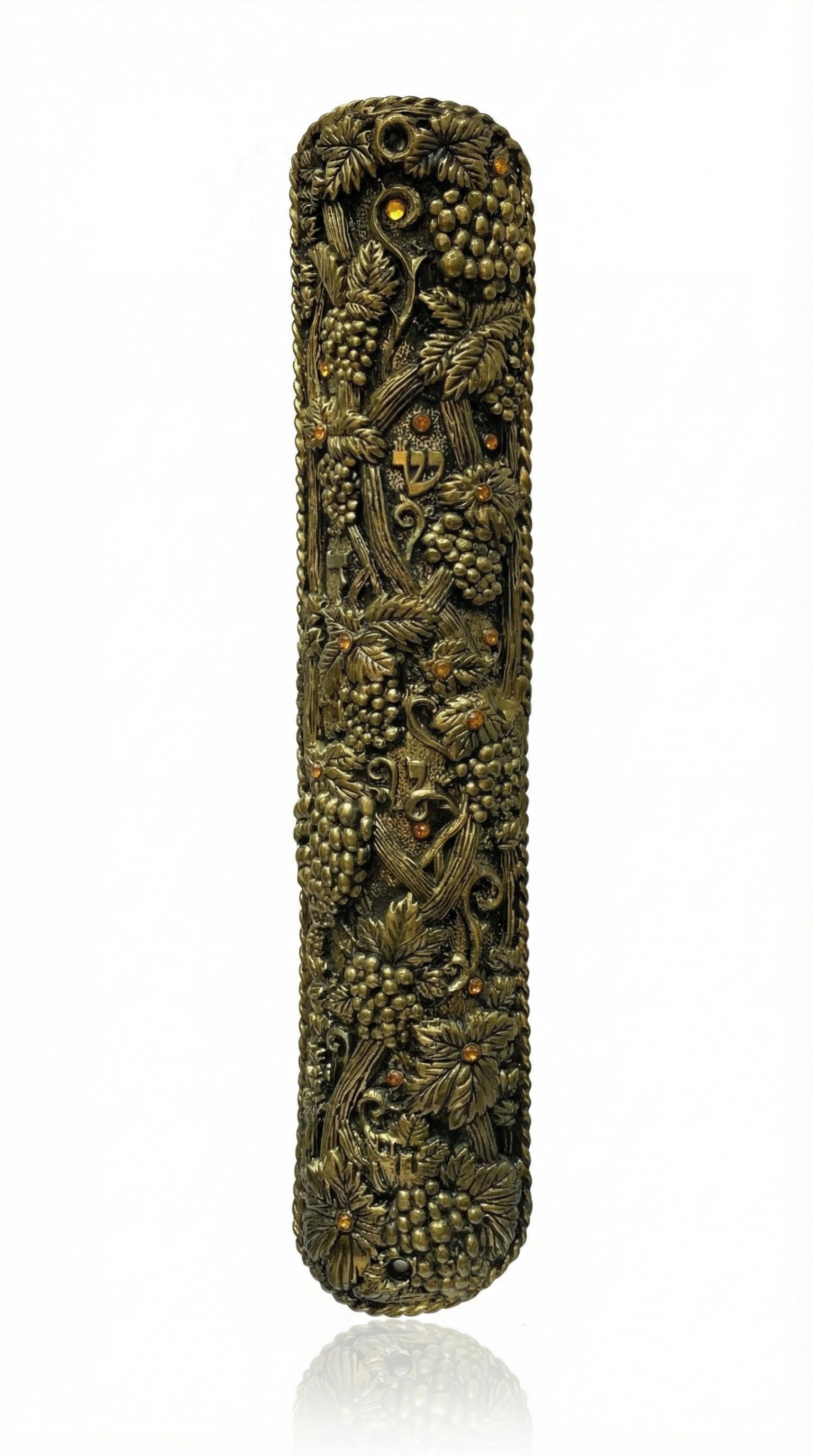 Large brass mezuzah with intricate details and Hebrew engravings, designed for front door installation, on a white background with soft reflection.