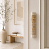 Divine Shin cream stone mezuzah installed on the right doorpost of a home entrance.