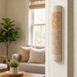 Five-inch Divine Shin stone mezuzah mounted vertically on the upper third of a doorpost.