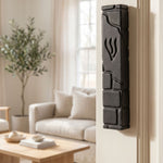 Hyper-realistic indoor doorway scene with black cement mezuzah mounted on the left side of the door frame, showcasing its details and placement.