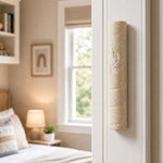 Real Jerusalem stone mezuzah mounted on a residential doorpost, positioned on the right, within the lower third, in a natural indoor doorway scene.