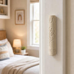 Real Jerusalem stone mezuzah mounted on a residential doorpost in an indoor setting, showcasing natural texture and material.