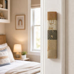 Photorealistic indoor scene showing the Jerusalem Stone Mezuzah mounted on a residential doorpost near the top, right side, with a room visible beyond.