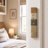 Photorealistic indoor scene showing the Jerusalem Stone Mezuzah mounted on a residential doorpost near the top, right side, with a room visible beyond.