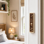Realistic indoor scene showing Jerusalem stone mezuzah mounted on residential doorpost near entrance, positioned on right side at lower third.