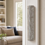 Real Jerusalem stone mezuzah mounted on a residential doorpost, positioned on the right side, showcasing natural material and Hebrew blessing.
