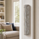 Real Jerusalem stone mezuzah mounted on a residential doorpost, positioned on the right side, showcasing natural material and Hebrew blessing.