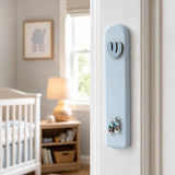 Realistic indoor scene showing New Baby Boy Mezuzah mounted on a residential doorpost beside an entryway.