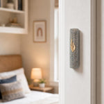 Real Jerusalem stone Mezuzah mounted on a doorpost in an indoor setting, showcasing its natural texture and horizontal lines.