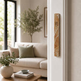 Real Jerusalem stone mezuzah mounted vertically on a residential doorpost, shown in natural indoor lighting at entrance, authentic and precise.