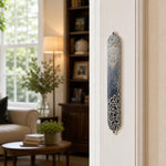 Realistic indoor scene showing the Elegant Swirls Blue Mezuzah mounted on a doorway doorpost.