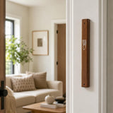 Mahogany wood mezuzah mounted on the right side of an indoor doorpost.
