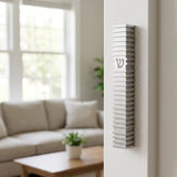 Modern Silver Steps aluminum mezuzah mounted on a narrow modern doorpost with a monochromatic waterproof profile and architectural texture