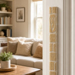 Nine-inch plain stone mezuzah mounted vertically on a residential doorpost.