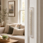 Clear acrylic Shema mezuzah mounted on a doorpost in a home entryway.
