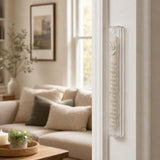 Clear acrylic Shema mezuzah mounted on a doorpost in a home entryway.