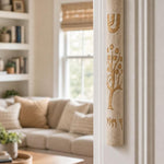 Etz Chaim cream stone mezuzah mounted on the right doorpost of a residential entrance.