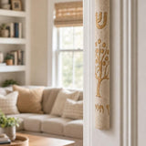 Etz Chaim cream stone mezuzah mounted on the right doorpost of a residential entrance.