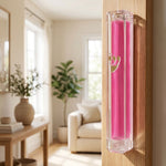 Stylish interior room with a doorway featuring a mounted pink Lucite Mezuzah, blended into a modern home decor setting.