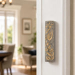 Indoor lifestyle scene with Jerusalem stone Mezuzah mounted on a residential doorpost on the right-hand side, natural lighting.