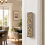 Indoor lifestyle scene with Jerusalem stone Mezuzah mounted on a residential doorpost on the right-hand side, natural lighting.