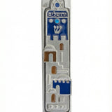 High-resolution image of a Jerusalem Dreamscape Mezuzah, hand-painted pewter with Hebrew inscriptions, set against a clean white studio background with subtle reflection.