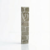 Handcrafted Jerusalem stone mezuzah in gray with detailed Hebrew engravings, displayed on a clean, white studio background with soft reflection.
