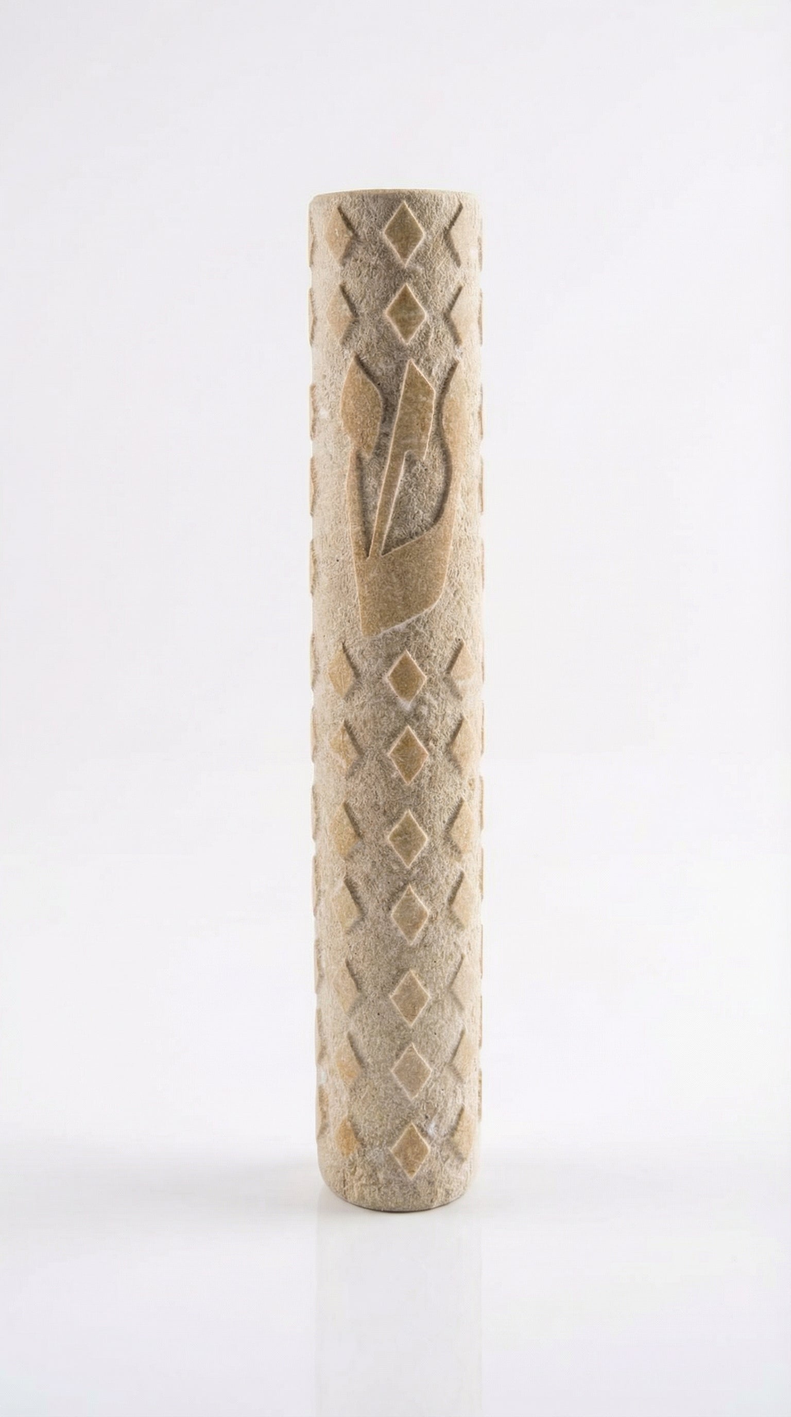High-resolution image of a handcrafted Jerusalem Stone mezuzah with detailed texture, engraved Hebrew words, and decorative motifs, on a white studio background with a subtle reflection.